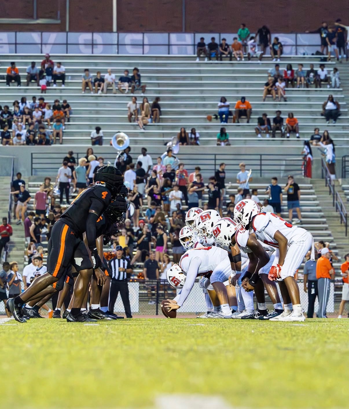 Brayson Albin over the ball at the line of scrimmage, ready to snap for Bob Jones HS